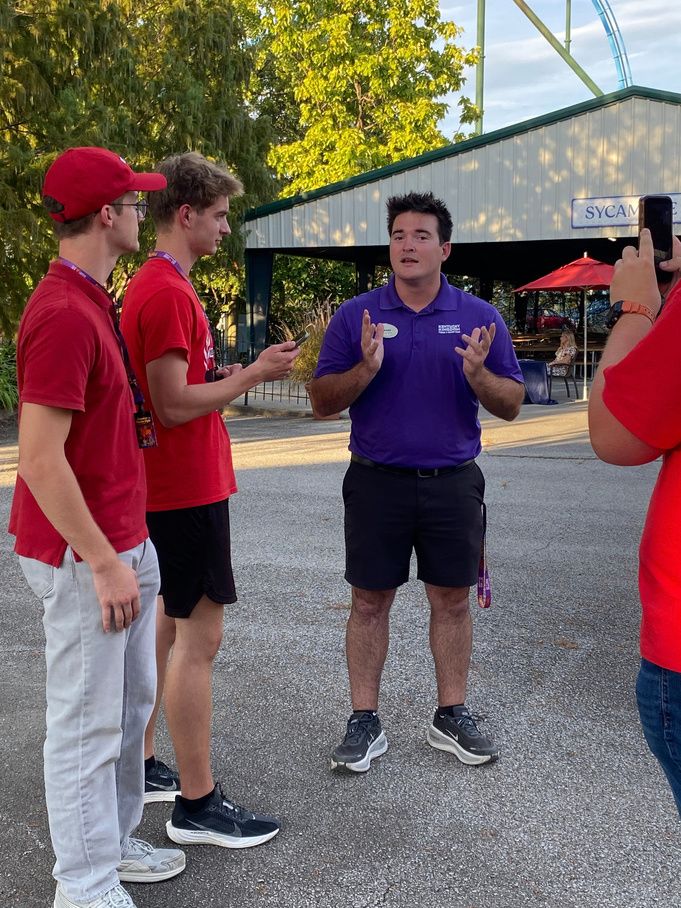 AJ Wyckoff and Micah Shively in red THRILL shirts interviewing James Atkinson II at Kentucky Kingdom