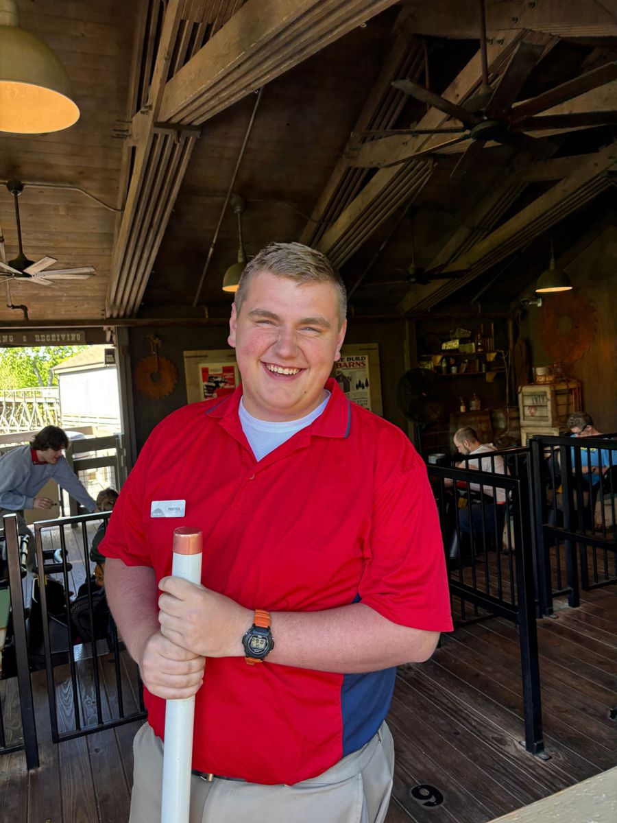 Preston Koeninger, THRILL founder and president, smiling in a red ride operator shirt
